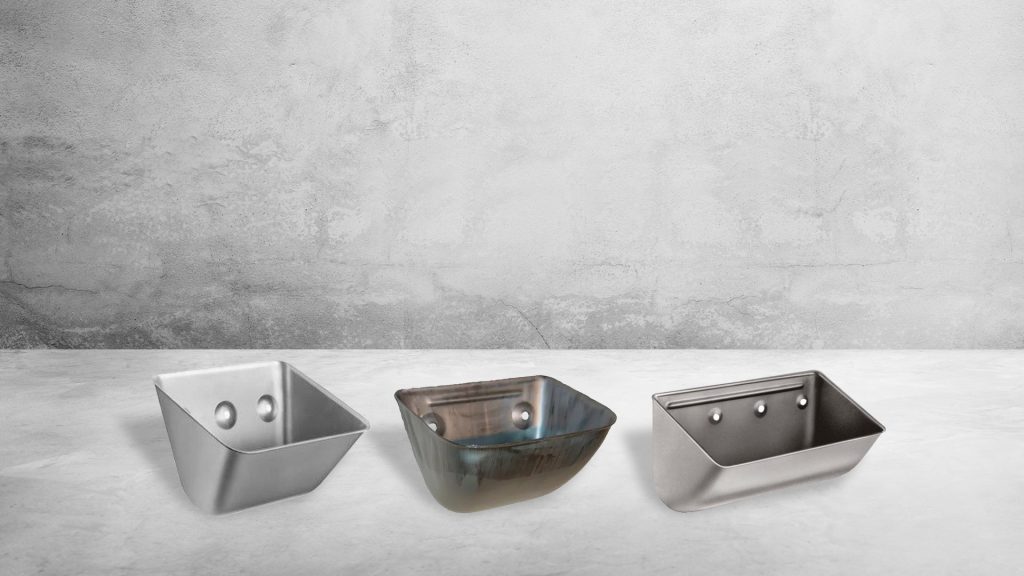 Three galvanized steel elevator buckets in three sizes displayed on concrete surface for grain handling and material conveying systems.